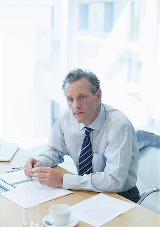 simsearch:614-06718128,k - Businessman sitting at desk in office Stock Photo - Premium Royalty-Free, Code: 6113-07159022