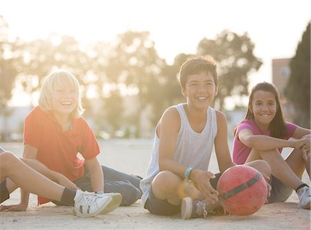 simsearch:6113-07159174,k - Children with soccer ball sitting outdoors Stock Photo - Premium Royalty-Free, Code: 6113-07159174