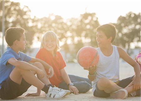 simsearch:6113-07159174,k - Children sitting with soccer ball outdoors Stock Photo - Premium Royalty-Free, Code: 6113-07159139