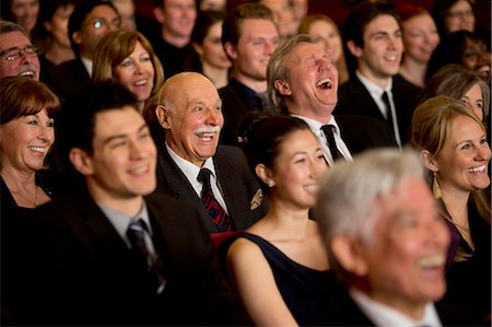 People smiling and laughing in theater audience Stock Photo - Premium Royalty-Free, Code: 6113-07159359