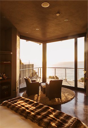 simsearch:6113-07159869,k - Luxury bedroom overlooking ocean at sunset Stock Photo - Premium Royalty-Free, Code: 6113-07159479