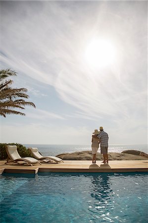 Older couple hugging by pool Stock Photo - Premium Royalty-Free, Code: 6113-07159565