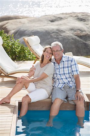 simsearch:6113-07159513,k - Older couple relaxing by swimming pool Stock Photo - Premium Royalty-Free, Code: 6113-07159591