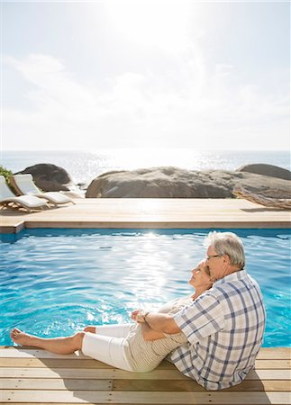 senior woman pool - Older couple relaxing by pool Stock Photo - Premium Royalty-Free, Code: 6113-07159658