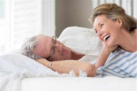 simsearch:6113-07159513,k - Older couple relaxing on bed Stock Photo - Premium Royalty-Free, Code: 6113-07159660