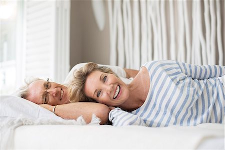simsearch:6113-07159513,k - Older couple relaxing together on bed Stock Photo - Premium Royalty-Free, Code: 6113-07159674
