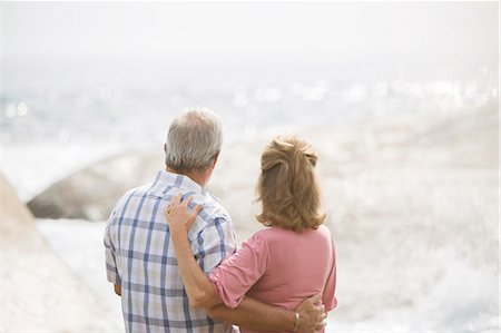 simsearch:6113-07159513,k - Older couple hugging on beach Stock Photo - Premium Royalty-Free, Code: 6113-07159690