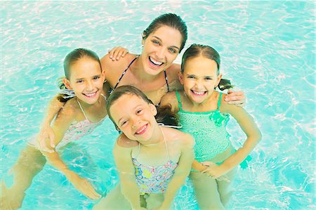 simsearch:6113-06909372,k - Mother and daughters swimming in pool Stock Photo - Premium Royalty-Free, Code: 6113-07159697