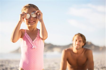 sand sea kids - Girl playing with seashells on beach Stock Photo - Premium Royalty-Free, Code: 6113-07159627