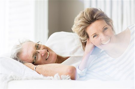 simsearch:6113-07159513,k - Older couple smiling on bed Stock Photo - Premium Royalty-Free, Code: 6113-07159629