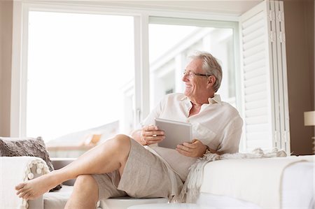simsearch:632-07161246,k - Older man using digital tablet in bedroom Stock Photo - Premium Royalty-Free, Code: 6113-07159637