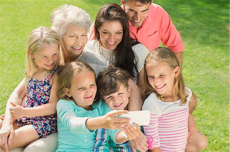 family photos with seniors - Family taking picture together with cell phone Stock Photo - Premium Royalty-Free, Code: 6113-07159741
