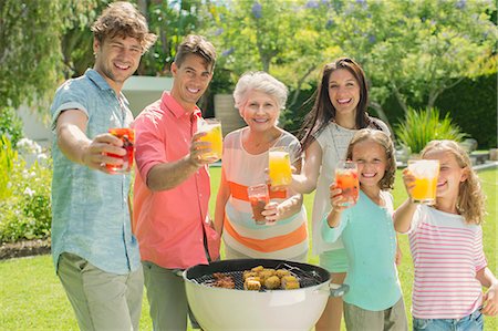 simsearch:6113-07159699,k - Family barbecuing together in backyard Stock Photo - Premium Royalty-Free, Code: 6113-07159712