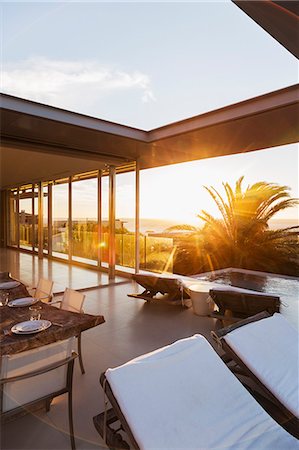 pool outside modern house - Lawn chairs and set table on modern patio Stock Photo - Premium Royalty-Free, Code: 6113-07159808