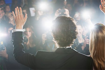 famous people - Rear view of celebrity couple waving to paparazzi Stock Photo - Premium Royalty-Free, Code: 6113-07159964