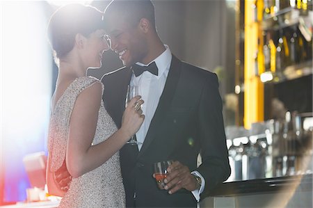 simsearch:6113-07543617,k - Well dressed couple hugging in luxury bar Stock Photo - Premium Royalty-Free, Code: 6113-07159988