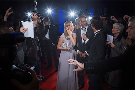 Well dressed celebrity couple being interviewed on red carpet Stock Photo - Premium Royalty-Free, Code: 6113-07160019