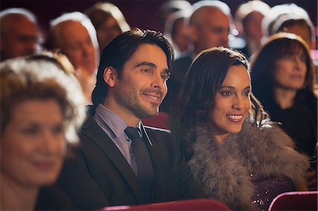 Close up of smiling couple in theater audience Stock Photo - Premium Royalty-Free, Code: 6113-07160103
