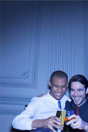 picture of gay men embracing - Well dressed men hugging and toasting beer and cocktail Stock Photo - Premium Royalty-Free, Code: 6113-07160118