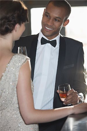 Close up of well dressed couple drinking cocktails in bar Stock Photo - Premium Royalty-Free, Code: 6113-07160132