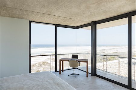 Desk in modern bedroom overlooking ocean Stock Photo - Premium Royalty-Free, Code: 6113-07160219