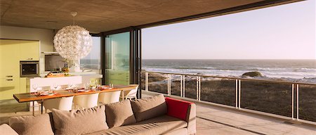 sliding door - Modern living room and dining room overlooking ocean Stock Photo - Premium Royalty-Free, Code: 6113-07160232