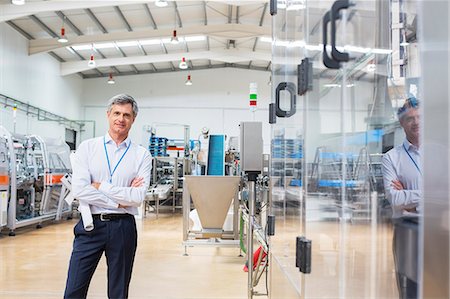 Businessman smiling in factory Stock Photo - Premium Royalty-Free, Code: 6113-07160343