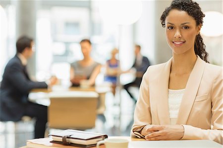 Businesswoman smiling in office Stock Photo - Premium Royalty-Free, Code: 6113-07160397