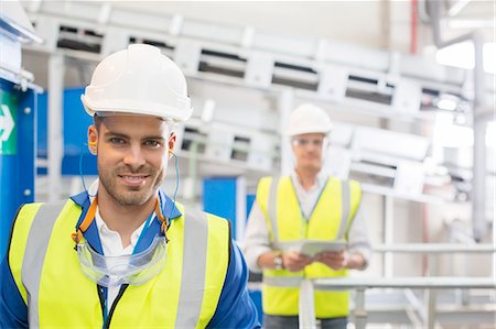 simsearch:6113-07160283,k - Workers smiling in factory Stock Photo - Premium Royalty-Free, Code: 6113-07160320