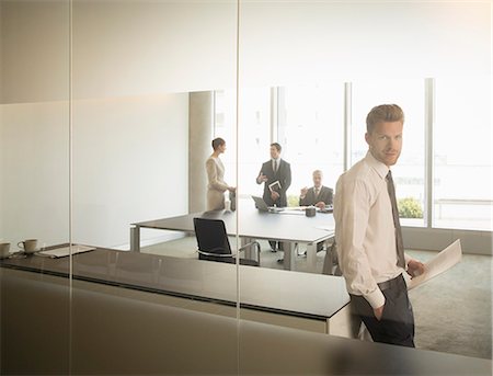 Businessman standing in office Stock Photo - Premium Royalty-Free, Code: 6113-07160435