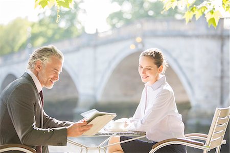 person tablet coffee shop - Business people working at sidewalk cafe Stock Photo - Premium Royalty-Free, Code: 6113-07160642