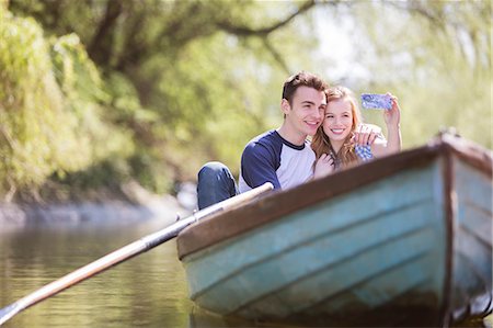 simsearch:632-07674444,k - Couple taking self-portraits in rowboat Stock Photo - Premium Royalty-Free, Code: 6113-07160627