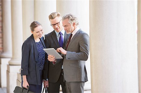 Business people using digital tablet outdoors Stock Photo - Premium Royalty-Free, Code: 6113-07160702