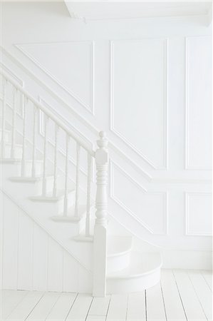 Banister and staircase in white foyer Stock Photo - Premium Royalty-Free, Code: 6113-07160737