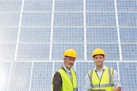 simsearch:6113-07160283,k - Workers standing under shade by solar panel Stock Photo - Premium Royalty-Free, Code: 6113-07160894
