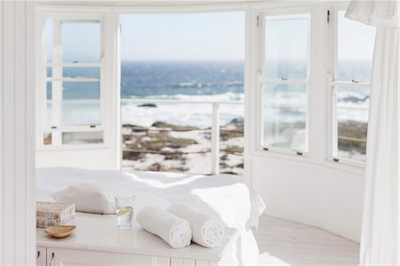 simsearch:6113-07731057,k - White bedroom overlooking ocean Foto de stock - Sin royalties Premium, Código: 6113-07160833