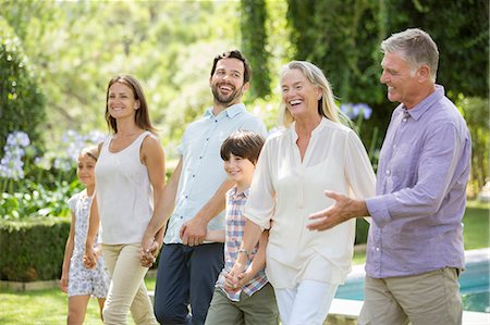 extended family walking outdoors - Multi-generation family walking in backyard Stock Photo - Premium Royalty-Free, Code: 6113-07241967