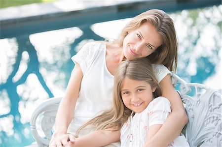 simsearch:6113-06909372,k - Mother and daughter relaxing at poolside Stock Photo - Premium Royalty-Free, Code: 6113-07241966