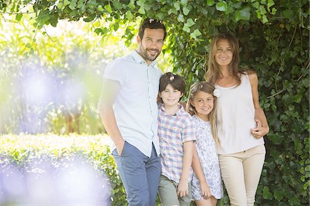 son hugging mom - Family smiling under ivy Stock Photo - Premium Royalty-Free, Code: 6113-07241994