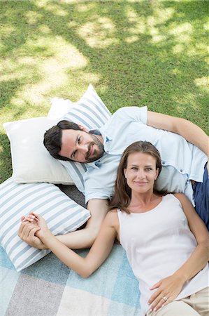 Couple relaxing on picnic blanket Stock Photo - Premium Royalty-Free, Code: 6113-07242054