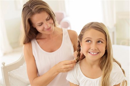 Mother braiding daughter's hair Stock Photo - Premium Royalty-Free, Code: 6113-07242099