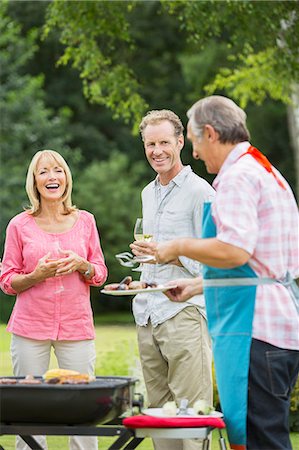 simsearch:6113-07242109,k - Family standing at barbecue in backyard Stock Photo - Premium Royalty-Free, Code: 6113-07242386