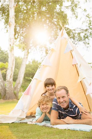 family yard - Father and children relaxing in teepee in backyard Stock Photo - Premium Royalty-Free, Code: 6113-07242398