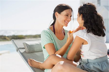 Mother and daughter relaxing at poolside Stock Photo - Premium Royalty-Free, Code: 6113-07242495