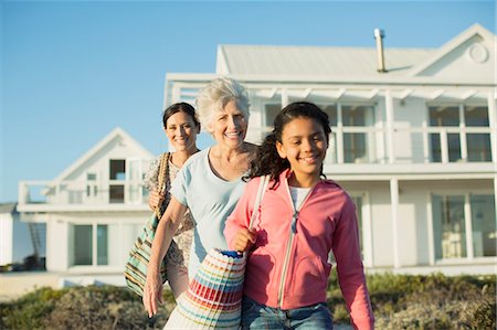 Multi-generation women walking on beach path outside house Stock Photo - Premium Royalty-Free, Code: 6113-07242570