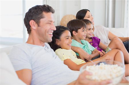 father hugging his son and daughter - Family watching TV on sofa Stock Photo - Premium Royalty-Free, Code: 6113-07242598