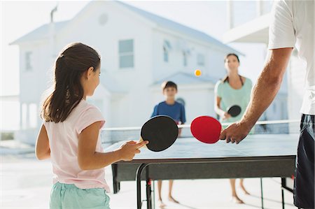 Family playing table tennis together outdoors Stock Photo - Premium Royalty-Free, Code: 6113-07242520
