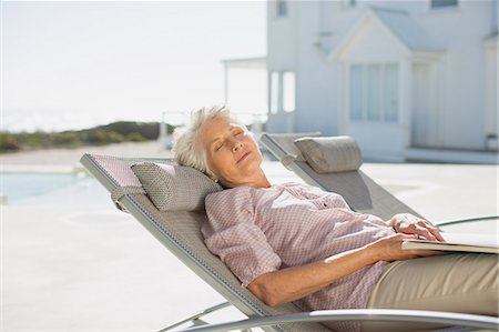 sleep book - Senior woman sleeping on lounge chair at poolside Stock Photo - Premium Royalty-Free, Code: 6113-07242533