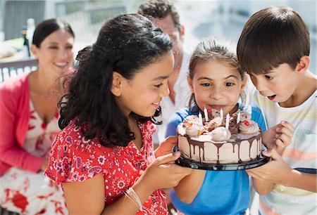 surprised kids - Children holding birthday cake outdoors Stock Photo - Premium Royalty-Free, Code: 6113-07242534