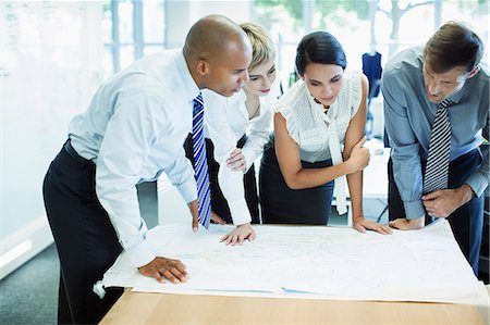 strategy table - Business people examining blueprints in office Stock Photo - Premium Royalty-Free, Code: 6113-07242688